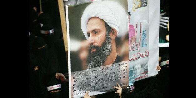 FILE - In this Sunday, Sept. 30, 2012 file photo, a Saudi anti-government protester carries a poster with the image of jailed Shiite cleric Sheik Nimr al-Nimr during the funeral of three Shiite Muslims allegedly killed by Saudi security forces in the eastern town of al-Awamiya, Saudi Arabia. Saudi Arabia says it has executed 47 prisoners, including leading Shiite cleric Sheikh Nimr al-Nimr. The clericâs name was among a list of the 47 prisoners executed carried by the state-run Saudi Press Agency. It cited the Interior Ministry for the information. (AP Photo, File)