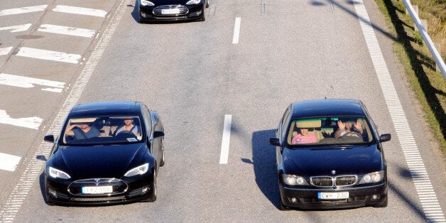 MALMO, SWEDEN - SEPTEMBER 21: Electric car owners from Scandinavia countries came together to campaign for greener transportation on Malmo-Hamburg road and form the longest electric car parade on the Oresund Bridge between Sweden and Denmark, on 21 September, 2014. (Photo by Irfan Cemiloglu/Anadolu Agency/Getty Images)