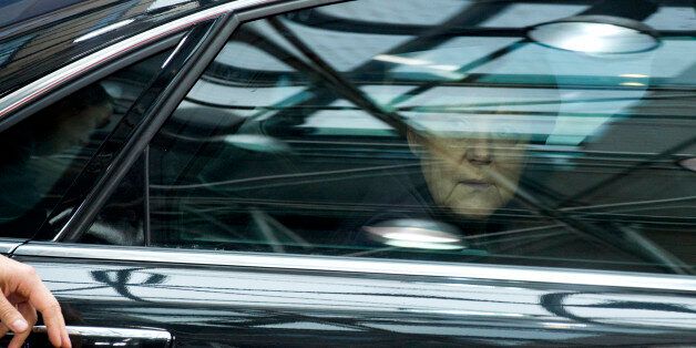 German Chancellor Angela Merkel looks out of her car window as she arrives for an EU summit at the EU Council building in Brussels on Thursday, Dec. 17, 2015. European Union heads of state meet Thursday to discuss, among other issues, the current migration crisis and terrorism. (AP Photo/Geert Vanden Wijngaert)