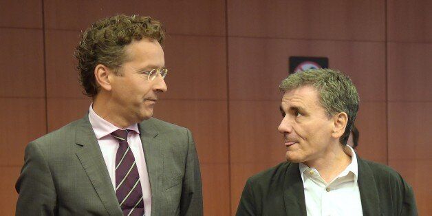 Greece's Finance Minister Euclid Tsakalotos (R) and Eurogroup President and Dutch Finance Minister Jeroen Dijsselbloem talk during an Eurogroup meeting at the EU headquarters in Brussels, on August 14, 2015. Greece's huge debt mountain remains a 'major point of concern' as eurozone finance ministers discuss whether to endorse a third bailout-for-reform deal, Eurogroup head Jeroen Dijsselbloem said. AFP PHOTO / EMMANUEL DUNAND (Photo credit should read EMMANUEL DUNAND/AFP/Getty Images)