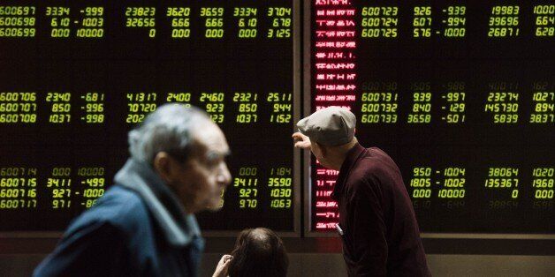 Investors look at screens showing stock market movements at a securities company in Beijing on January 7, 2016. Chinese markets were suspended on January 7 for the second day this week after they fell more than seven percent, leading an Asia-wide sell-off as China weakened the value of the yuan currency by the most since August. AFP PHOTO / FRED DUFOUR / AFP / FRED DUFOUR (Photo credit should read FRED DUFOUR/AFP/Getty Images)