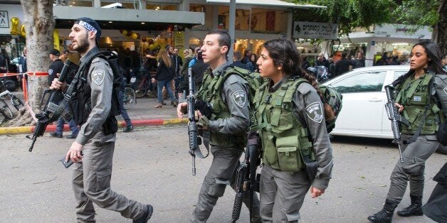 Members of the Israeli security forces search the area following an attack by an unidentified gunman, who opened fire at a pub in the Israeli city of Tel Aviv killing two people and wounding at least seven others on January 1, 2016, police and medical officials said. An eyewitness told Channel 1 television the assailant used an automatic weapon against people at a pub. AFP PHOTO / JACK GUEZ / AFP / JACK GUEZ (Photo credit should read JACK GUEZ/AFP/Getty Images)