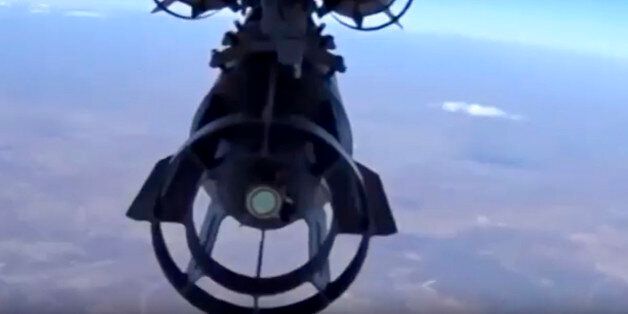 In this photo made from the footage taken from Russian Defense Ministry official web site on Tuesday, Nov. 17, 2015, a Russian bomber drops bombs on a target in Syria. Russia's defense minister said its warplanes have fired cruise missiles on militant positions in Syria's Idlib and Aleppo provinces. The Islamic State group has positions in Aleppo province; Idlib has the presence of the Nusra militant group. (AP Photo/ Russian Defense Ministry Press Service)