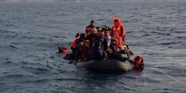 IZMIR, TURKEY - JANUARY 4: Refugees are seen on a boat after they were rescued by Turkish coast guard in the Aegean Sea, in Izmir, Turkey on January 4, 2016. Turkish Coast Guards rescued 241 people while they were illegally trying to cross Aegean Sea. (Photo by Turkish Coast Guard Command /Anadolu Agency/Getty Images)