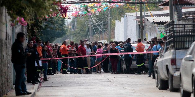 Local residents gather on January 2, 2016 outside the house of Gisela Mota, newly elected Mayor of Temixco, Morelos State, Mexico, murdered on Saturday at home by gunmen. AFP PHOTO/Pedro PARDO / AFP / Pedro PARDO (Photo credit should read PEDRO PARDO/AFP/Getty Images)