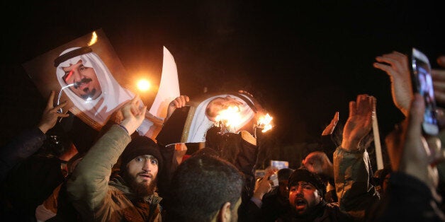 Iranian protesters gather outside the Saudi Embassy in Tehran during a demonstration against the execution of prominent Shiite Muslim cleric Nimr al-Nimr by Saudi authorities, on January 2, 2016. Nimr was a driving force of the protests that broke out in 2011 in Saudi Arabia's east, an oil-rich region where the Shiite minority of an estimated two million people complains of marginalisation. AFP PHOTO / ATTA KENARE / AFP / ATTA KENARE (Photo credit should read ATTA KENARE/AFP/Getty Images)