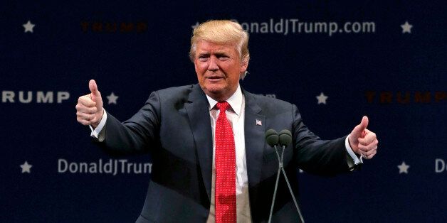 Republican presidential candidate Donald Trump flashes thumbs up after an address to a group of supporters at a campaign stop at the Flynn Center of the Performing Arts in Burlington, Vt., Thursday, Jan. 7, 2016. (AP Photo/Charles Krupa)