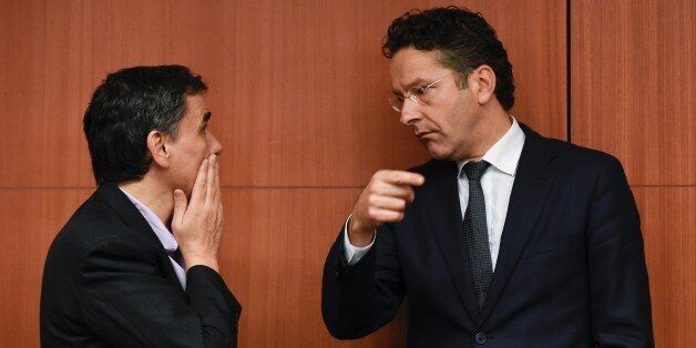 Greek Finance Minister Euclid Tsakalotos (L) speaks with Dutch Finance Minister and president of the Eurogroup Jeroen Dijsselbloem (R) during a Eurogroup meeting at the EU headquarters in Brussels on December 7, 2015. / AFP / JOHN THYS (Photo credit should read JOHN THYS/AFP/Getty Images)