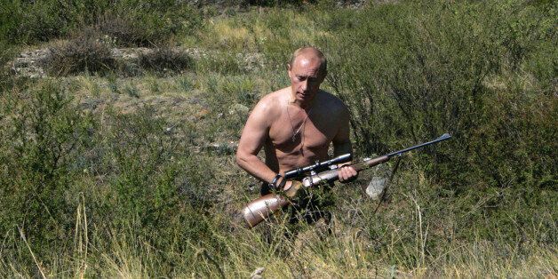 This pool picture provided 03 September 2007 shows Russian President Vladimir Putin carrying a hunting rifle in the Republic of Tuva, 15 August 2007. Putin is scheduled to visit Australia for the ASEAN conference starting this week. AFP PHOTO / RIA NOVOSTI / KREMLIN POOL / DMITRY ASTAKHOV (Photo credit should read DMITRY ASTAKHOV/AFP/Getty Images)