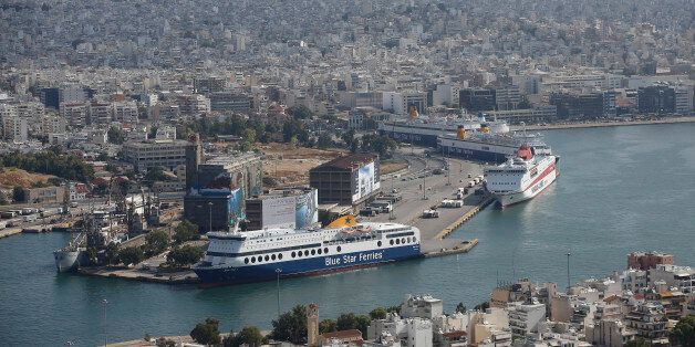 Cruise ships, operated by Blue Star Ferries Maritime SA, sit on the dockside at the commercial ferry port in Athens, Greece, on Thursday, June 25, 2015. Greece could tap euro-area funds of as much as 3.35 billion euros ($3.75 billion) by early July if it can reach a deal with its creditors, thanks to profit-sharing pledges from member nations' central banks. Photographer: Simon Dawson/Bloomberg via Getty Images