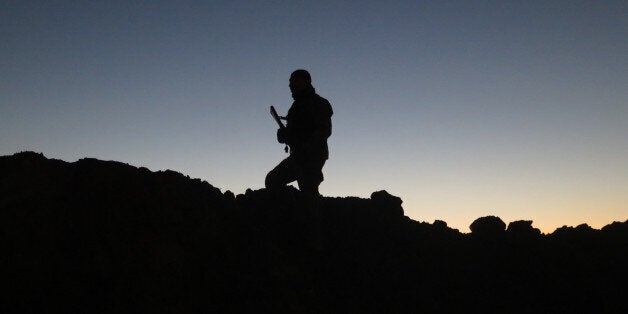 TOPSHOT - TO GO WITH AFP STORY BY JEAN-MARC MOJONKim, a French volunteer in the fight against the Islamic State (IS) group, looks towards a jihadist position during a reconnaissance mission with the Iraqi Kurdish peshmerga forces on December 7, 2015 in Daquq, a town around 200 kilometres (120 miles) north of Baghdad. He is part of a group of six French volunteers, most of them former servicemen, who call themselves Unit 732 and assist the peshmerga, mostly by carrying out reconnaissance missions and training sessions. / AFP / JEAN-MARC MOJON (Photo credit should read JEAN-MARC MOJON/AFP/Getty Images)