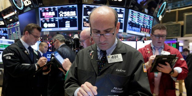 Trader Andrew Silverman, center, works on the floor of the New York Stock Exchange, Tuesday, Dec. 15, 2015. Stocks are climbing in early trading as buyers return to a market that has been mostly beaten down in recent days. (AP Photo/Richard Drew)