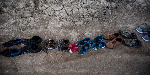 Shoes used by refugees when crossing the Aegean sea from Turkey to Greece remain drying up on a beach, on the island of Lesbos, on Thursday, Dec. 24, 2015.The Geneva-based International Organization for Migrants says more than 1 million people have entered Europe as of Monday. Almost all came by sea, while 3,692 drowned in the attempt.(AP Photo/Santi Palacios)