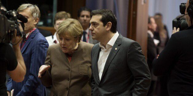 German Chancellor Angela Merkel (L) speaks with Greek Prime Minister Alexis Tsipras (R) before the final European Union (EU) summit of the year at the European Council in Brussels on December 18, 2015. / AFP / JOHN THYS (Photo credit should read JOHN THYS/AFP/Getty Images)