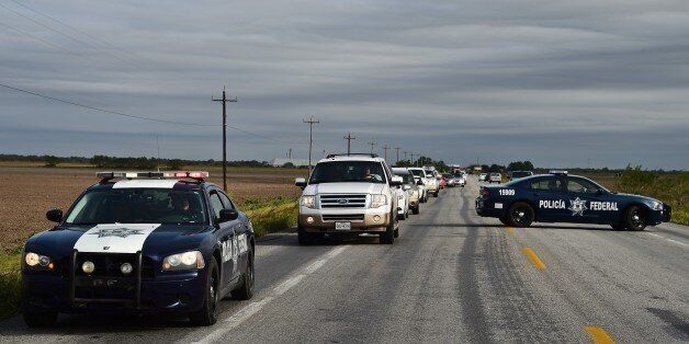 TO GO WITH AFP STORY BY SOFIA MISELEMFederal Police patrol cars escort vehicles with civilians along the gang-infested Matamoros-Ciudad Victoria highway, Tamaulipas State, Mexico, in the border with the United States, on December 16, 2015. AFP PHOTO/RONALDO SCHEMIDT / AFP / RONALDO SCHEMIDT (Photo credit should read RONALDO SCHEMIDT/AFP/Getty Images)