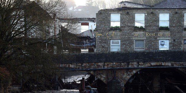 Damage to The Waterside Pub, a two hundred year old public house is pictured on December 27, 2015, the day after the River Irwell, swelled by exceptionally heavy rainfall swept through the village of Summerseat in Greater Manchester causing widespread damage. Britain's government was holding emergency talks Sunday as flooding in northern England forced hundreds of people to leave their homes, including in the historic tourist destination of York. AFP PHOTO / PAUL ELLIS / AFP / PAUL ELLIS (Photo credit should read PAUL ELLIS/AFP/Getty Images)
