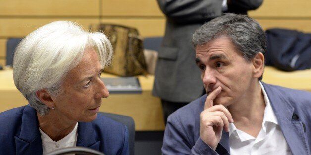 Greek Finance Minister Euclid Tsakalotos (R) speaks with Managing Director of the International Monetary Fund (IMF) Christine Lagarde during a meeting of the Eurogroup finance ministers in Brussels on July 12, 2015. The EU cancelled a full 28-nation summit today to decide Greece's fate in the single European currency, although a meeting of leaders from the 19 countries in the eurozone will go ahead as planned. AFP PHOTO / THIERRY CHARLIER (Photo credit should read THIERRY CHARLIER/AFP/Getty Images)