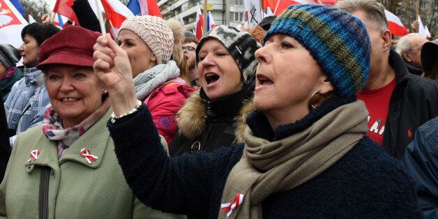 Protesters shout slogans during an anti government demonstration in Warsaw on December 19, 2015. Thousands of Poles participated in demonstrations across Poland to protest moves by the new right-wing government to neutralize the Constitutional Tribunal as a check on its power. / AFP / JANEK SKARZYNSKI (Photo credit should read JANEK SKARZYNSKI/AFP/Getty Images)