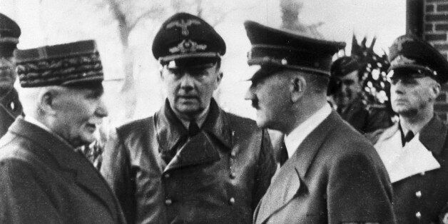 FILE - This Oct. 24, 1940 file photo shows German Chancellor Adolf Hitler, right, shaking hands with Head of State of Vichy France Marshall Philippe Petain, in occupied France. Behind centre is Paul Schmidt an interpreter and right is German Minister of Foreign Affairs Joachim Von Ribbentrop. France is opening police and legal archives from the collaborationist Vichy regime, allowing free access to previously classified documents from World War II. The order, signed Dec. 24 and effective Monday, allows anyone access to the archives that, among other things, show the extra-legal prosecution of members of the French Resistance, as well as proceedings against French Jews. (AP Photo, File)