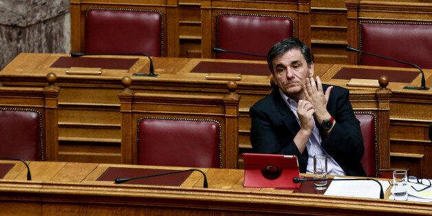 Greece's Finance Minister Euclid Tsakalotos attends a parliamentary session ahead of a voting, in Athens, on Tuesday, Dec. 15, 2015. Greek parliament votes on reforms needed for the country to receive further financial aid from its international lenders. (AP Photo/ Yorgos Karahalis )