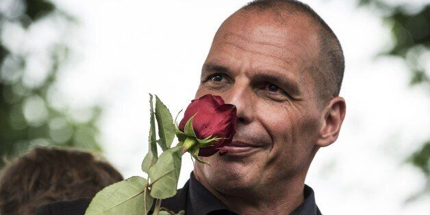 Former Greek Finance Minister Yanis Varoufakis smells a rose during the 43rd annual Fete de la Rose political meeting on August 23, 2015 in Frangy-en-Bresse. AFP PHOTO / JEAN-PHILIPPE KSIAZEK (Photo credit should read JEAN-PHILIPPE KSIAZEK/AFP/Getty Images)