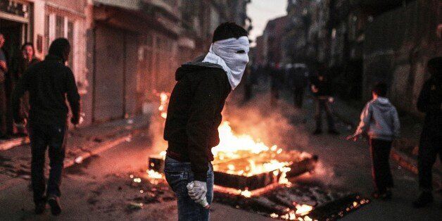 A masked protester holds a petrol bomb during clashes with Turkish police using water cannons and tear gas to disperse a demonstration in Istanbul protesting security operations against Kurdish rebels in southeastern Turkey on December 20, 2015.The number of Kurdish rebels killed in a massive Turkish military offensive in the restive southeast has jumped to 102, a security source told AFP, as the operation entered its fifth day. The government has imposed curfews in the mainly Kurdish towns of Cizre and Silopi as security forces battle militants linked to the Kurdistan Workers' Party (PKK). / AFP / Cagdas Erdogan (Photo credit should read CAGDAS ERDOGAN/AFP/Getty Images)