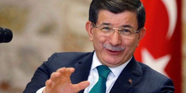 Turkish Prime Minister Ahmet Davutoglu speaks to a group of foreign reporters in Istanbul, Turkey, Wednesday, Dec. 9, 2015. Davutoglu has accused Russia of attempting