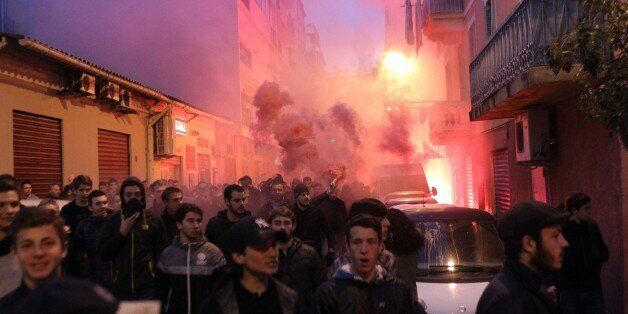 Demonstrators march towards the prefecture in Ajaccio during a protest on December 26, 2015, a day after demonstrators vandalised a Muslim prayer hall and trashed copies of the Koran, following a night of violence that left two firefighters and a police officer injured.Dozens of angry Corsicans staged a fresh protest on the French Mediterranean island today. As condemnation poured in from Muslim authorities and French officials over Friday's anti-Arab protests, around 100 demonstrators shouting 'We're still here' turned out in the same low-income neighbourhood of the capital Ajaccio where the Christmas day violence took place. / AFP / YANNICK GRAZIANI (Photo credit should read YANNICK GRAZIANI/AFP/Getty Images)