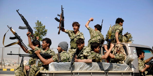 FILE - In this Monday, Dec. 14, 2015 photo, Shiite fighters, known as Houthis, ride on a patrol truck as they chant slogans during a tribal gathering showing support for the Houthi movement in Sanaa, Yemen. (AP Photo/Hani Mohammed, File)