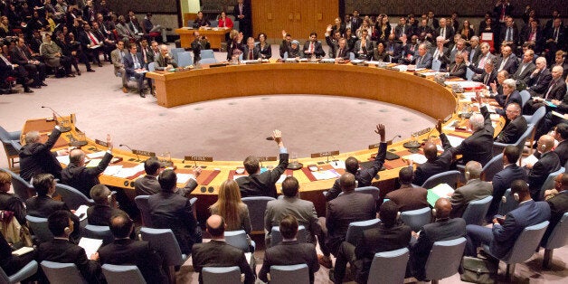 A gathering in the U.N. Security Council of foreign ministers lead by U.S. Secretary of State John Kerry vote on a draft resolution concerning Syria, Friday, Dec. 18, 2015 at U.N. headquarters. U.N. Security Council members have unanimously approved a U.N. resolution endorsing a peace process for Syria including a cease-fire and talks between the Damascus government and the opposition. (AP Photo/Bebeto Matthews)