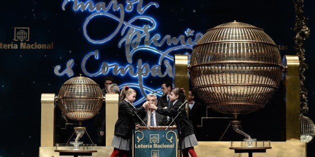 MADRID, SPAIN - DECEMBER 22: Pupils are seen during the traditional Spanish 'El Gordo' Christmas lottery draw at the Royal Opera House in Madrid, Spain, 22 December 2015. (Photo by Burak Akbulut/Anadolu Agency/Getty Images)