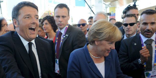 MILAN, ITALY - AUGUST 17: (L-R)Italian Prime Minister Matteo Renzi and German Chancellor Angela Merkel attend the visit at the pavilion of Italy during the visit of German Chancellor Angela Merkel at Expo 2015 on August 17, 2015 in Milan, Italy. (Photo by Pier Marco Tacca/Getty Images)