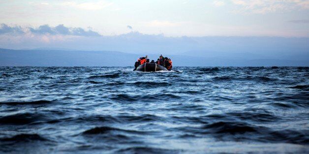 Migrants and refugees approach on a dinghy the northeastern Greek island of Lesbos from the Turkish coast, on Wednesday, Dec. 9, 2015. Greek authorities say in another incident at the southeastern Greek islet of Farmakonissi at least 12 people have died and 26 are missing after a boat carrying about 50 migrants sank in Aegean Sea. (AP Photo/Santi Palacios)