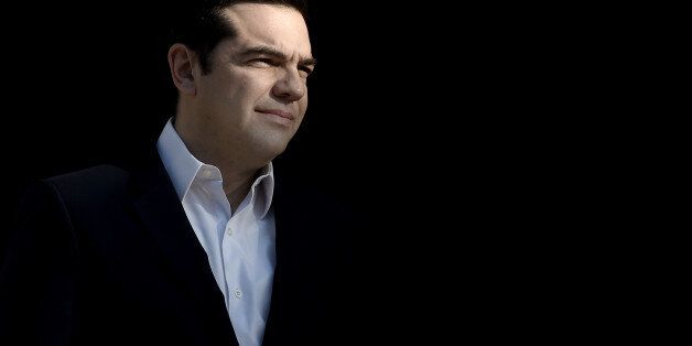 Greek Prime Minister Alexis Tsipras looks on as he waits for the Palestinian president in Athens on December 21, 2015. AFP PHOTO / ARIS MESSINIS / AFP / ARIS MESSINIS (Photo credit should read ARIS MESSINIS/AFP/Getty Images)