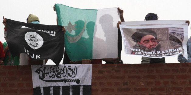 SRINAGAR, INDIA - AUGUST 21: Kashmiri protesters shout anti-India and pro-Pakistan slogans as they hold Pakistani, ISIS, Lashkar-e-Taiba flags and a picture of ISIS leader Abu Bakr al-Baghdadi during a protest after Friday prayers outside Jamia Masjid on August 21, 2015 in Srinagar, India. The talks between Indian and Pakistan National Security Advisors (NSA) scheduled on August 23 is in jeopardy following Indiaâs hardening of stand against Pakistan for inviting Kashmiri separatist leaders