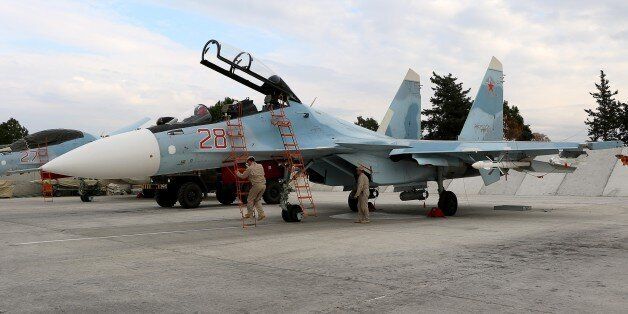 Russian servicemen prepare a Russian Sukhoi Su-30SM fighter jet before a departure for a mission at the Russian Hmeimim military base in Latakia province, in the northwest of Syria, on December 16, 2015. Russia began its air war in Syria on September 30, conducting air strikes against a range of anti-regime armed groups including US-backed rebels and jihadist groups. Moscow has said it is fighting and other 'terrorist groups,' but its campaign has come under fire by Western officials who accuse the Kremlin of seeking to prop up Syrian President Bashar al-Assad. / AFP / Paul GYPTEAU (Photo credit should read PAUL GYPTEAU/AFP/Getty Images)