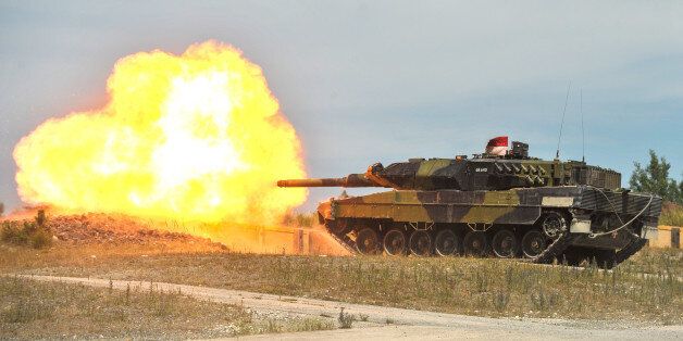 A Royal Danish Army Leopard 2 tank fires at a target during a live-fire exercise at the 7th Army Joint Multinational Training Command's Grafenwoehr Training Area, Germany, July 04, 2014. The 7th Army JMTC provides dynamic training, preparing forces to execute Unified Land Operations and contingencies in support of the Combatant Commands, NATO, and other national requirements.(U.S. Army photo by Visual Information Specialist Markus Rauchenberger/released)