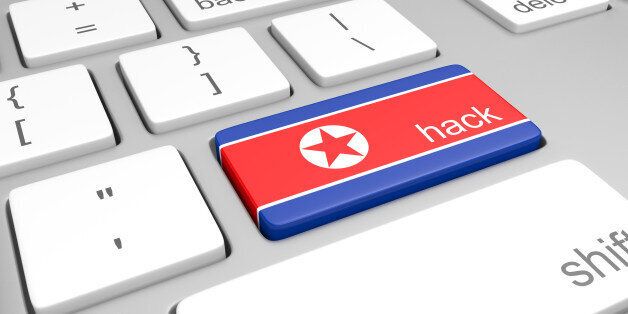 Closeup of keys on a computer keyboard, with one bearing the North Korean flag colors and a label for hacking.
