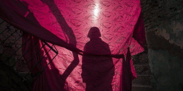 DIYARBAKIR, TURKEY - DECEMBER 24: A shadow of a Turkish Security forces member standing behind a curtain is seen in a school building damaged by the PKK terrorists as troops conduct counter-terrorism operation in Turkeys southeastern Diyarbakir provinces Sur district on December 24, 2015. (Photo by Stringer/Anadolu Agency/Getty Images)