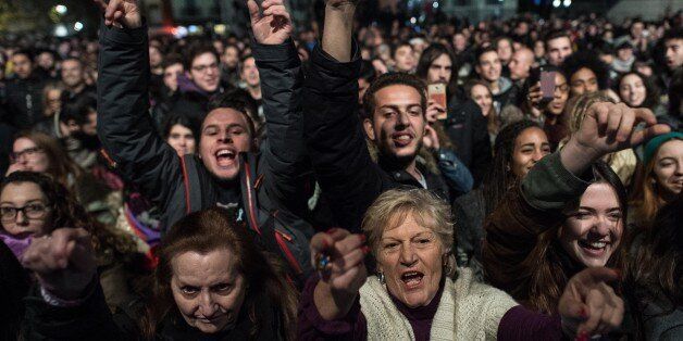 BARCELONA, SPAIN - DECEMBER 20: Podemos (We Can) supporters cheer at the first exit poll results on December 20, 2015 in Madrid, Spain. Spaniards went to the polls today to vote for 350 members of the parliament and 208 senators. For the first time since 1982, the two traditional Spanish political parties, right-wing Partido Popular (People's Party) and centre-left wing Partido Socialista Obrero Espanol PSOE (Spanish Socialist Workers' Party), held a tight election race with two new contenders, Ciudadanos (Citizens) and Podemos (We Can) attracting right-leaning and left-leaning voters respectively. (Photo by David Ramos/Getty Images)