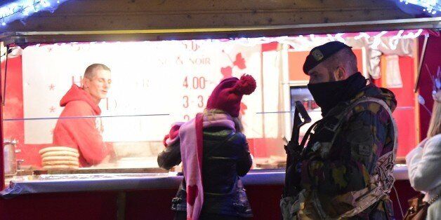 A Belgian soldier patrols during the opening night of the annual Christmas market on November 27, 2015 in Brussels. Belgium reduced the terrorism alert in Brussels from its highest possible level on November 26 after Prime Minister Charles Michel said the threat of a Paris-style jihadist attack was no longer as imminent. AFP PHOTO / EMMANUEL DUNAND / AFP / EMMANUEL DUNAND (Photo credit should read EMMANUEL DUNAND/AFP/Getty Images)