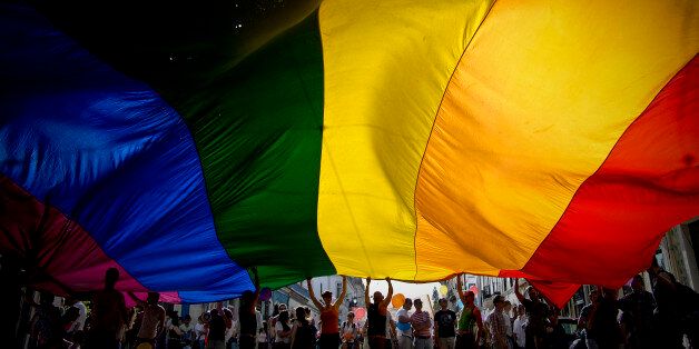 People wave a giant rainbow flag during the Gay Pride Parade in Lisbon on June 22, 2013. AFP PHOTO/ PATRICIA DE MELO MOREIRA (Photo credit should read PATRICIA DE MELO MOREIRA/AFP/Getty Images)