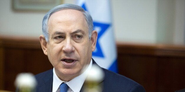 Israeli Prime Minister Benjamin Netanyahu opens the weekly cabinet meeting at his Jerusalem office on December 6, 2015. AFP PHOTO / POOL / JIM HOLLANDER / AFP / POOL / JIM HOLLANDER (Photo credit should read JIM HOLLANDER/AFP/Getty Images)