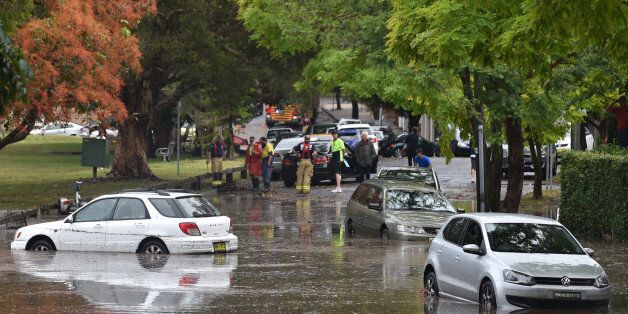 Inundated cars are seen on a flooded street after a storm in the eastern suburbs of Sydney on December 16, 2015. Sydney was smashed by a tornado-like storm with hail as big as golf balls and winds gusting at 200 kilometres (124 miles) an hour causing havoc with two people requiring treatment -- one for shock and one for a head wound -- in the hardest-hit suburb of Kurnell, an ambulance official said. AFP PHOTO / Peter PARKS / AFP / PETER PARKS (Photo credit should read PETER PARKS/AFP/Getty Images)
