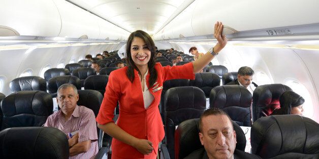 NEW DELHI,INDIA MAY 20: Air Hostess inside the Aeroplane during the launch of Air Asia flight at IGI AirportT3, New Delhi.(Photo by Chandradeep Kumar/India Today Group/Getty Images)