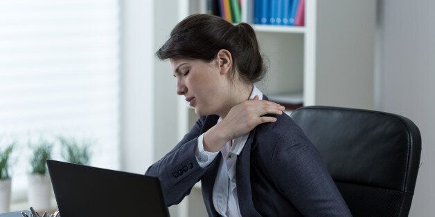 Businesswoman leading sedentary lifestyle causing back pain