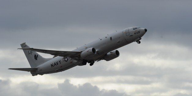 A US Navy P-8 Poseidon aircraft flies out from Perth International Airport on April 16, 2014 to help in the search for missing Malaysia Airlines flight MH370. Meanwhile, a mini-sub searching for missing Flight MH370 was again sweeping the Indian Ocean seabed on April 16 after aborting its first mission, officials said, as Malaysia vowed to reveal any 'black box' data found. AFP PHOTO / POOL / Greg WOOD (Photo credit should read GREG WOOD/AFP/Getty Images)