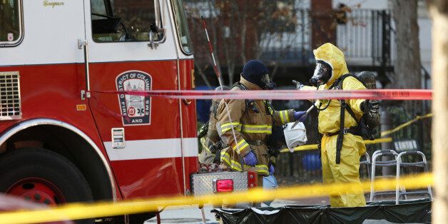 Firefighters are seen near the headquarters of the Council on American-Islamic Relations (CAIR) on Capitol Hill in Washington, Thursday, Dec. 10, 2015, after the building was evacuated. A spokesman for a Muslim group said its headquarters on Capitol Hill have been evacuated after staffers came in contact with a suspicious substance that arrived in the mail. (AP Photo/Pablo Martinez Monsivais)
