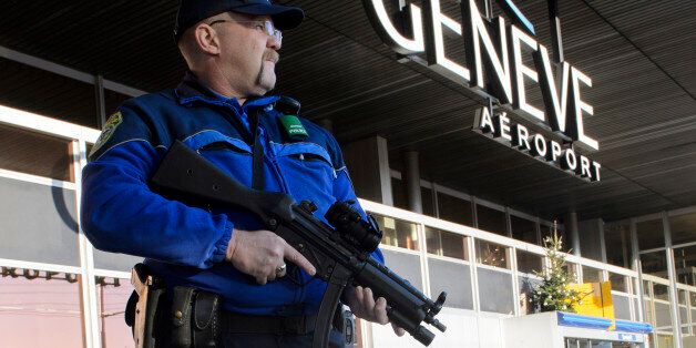 TOPSHOT - An armed policeman patrols on December 12, 2015 at Geneva Airport in Geneva. Two men of Syrian origin were arrested on December 11 in Geneva with traces of explosives in their car, Swiss public television said, as the city remained on high alert due to an increased jihadist threat. The Geneva region raised its alert level to three on a five-point scale on December 10, and armed police have been deployed at sensitive locations across the western city, which is home to the UN's European