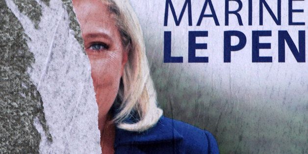 A torn poster of French far-right party leader Marine Le Pen is seen in Henin-Beaumont, northern France, Friday, Dec. 11, 2015. Le Pen is in the race for the presidency of the French northern region. The second round of the regional elections will take place Sunday. (AP Photo/Michel Spingler)
